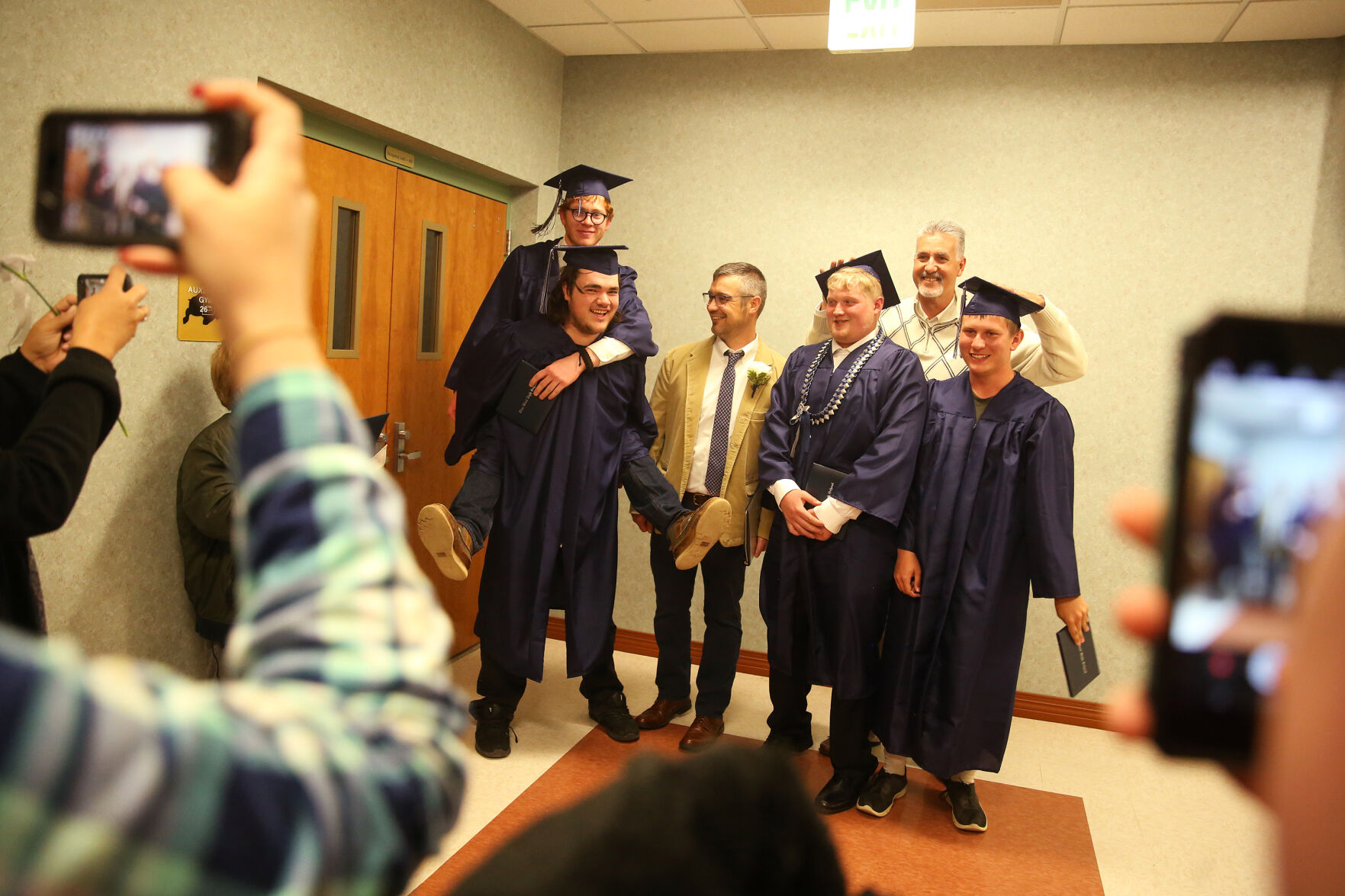 Joe Burtenshaw, Sebastian Henry, Triston Peter and Cory Langevin grab teacher Mike Hanson